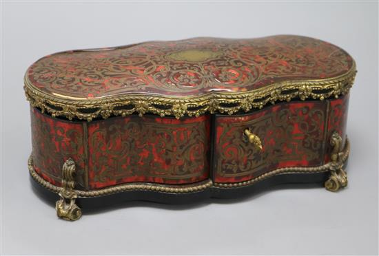 A boulle gilt metal mounted shaped rectangular casket, with lifting top and two doors, inlaid with brass scroll work, length 29cm